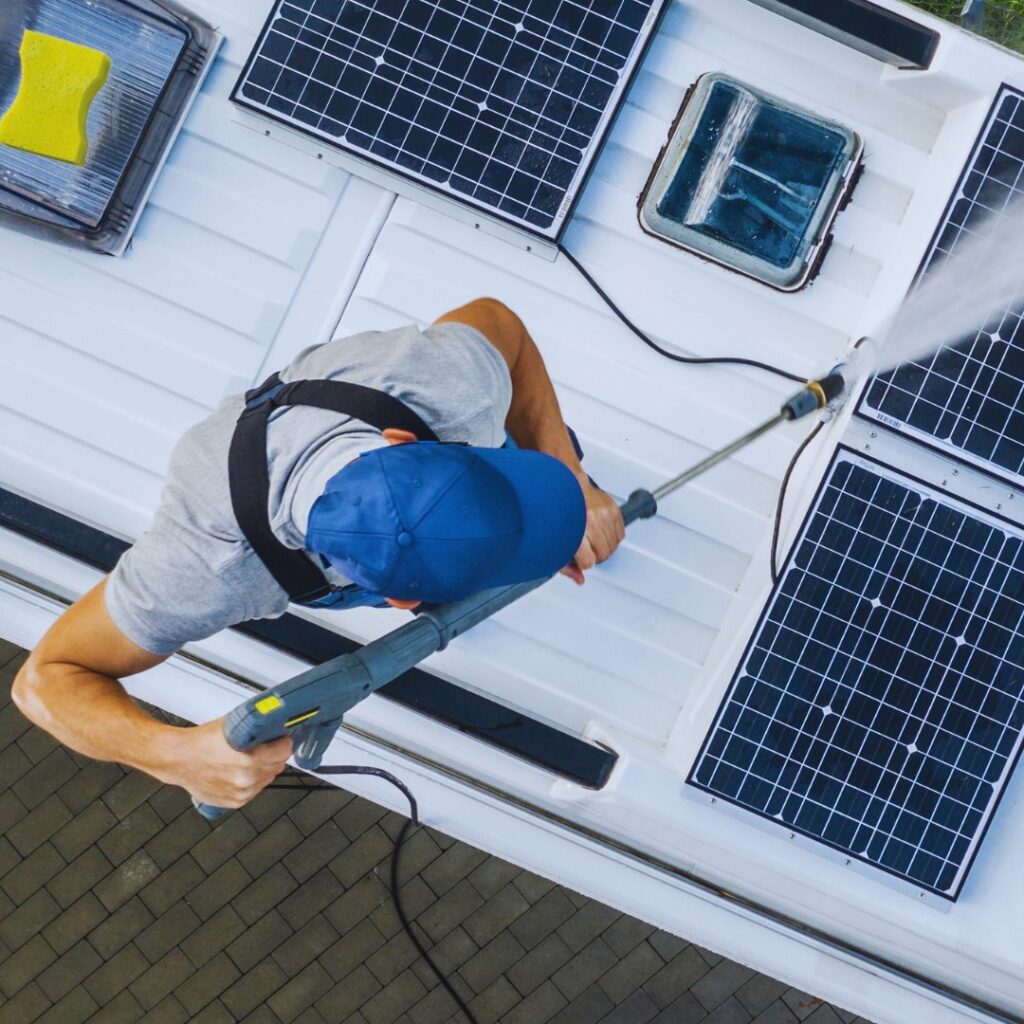 Man cleaning a RV and its solar panels