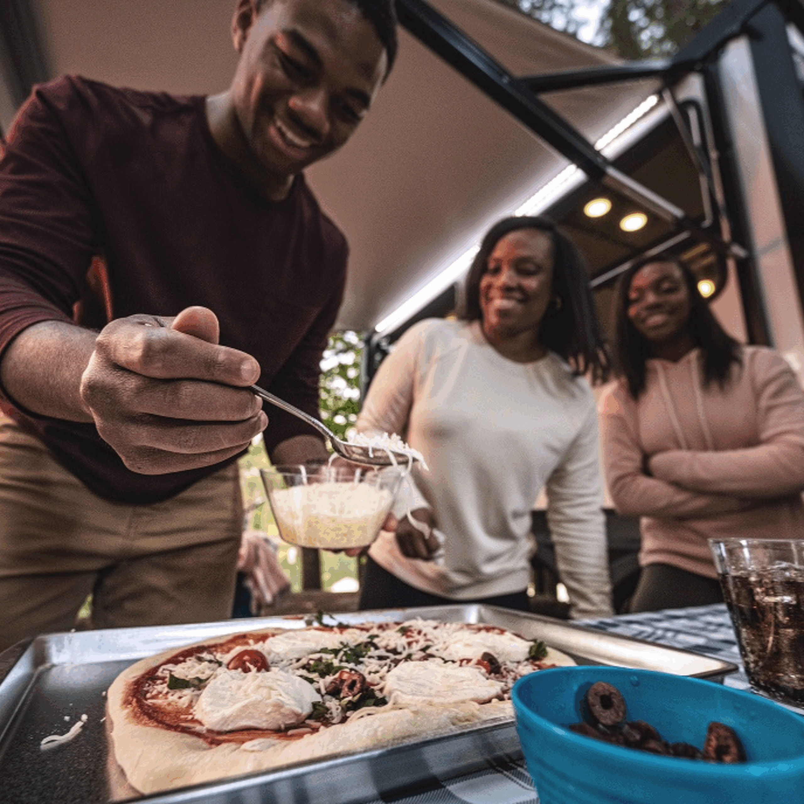 Family making homemade pizza in a camper