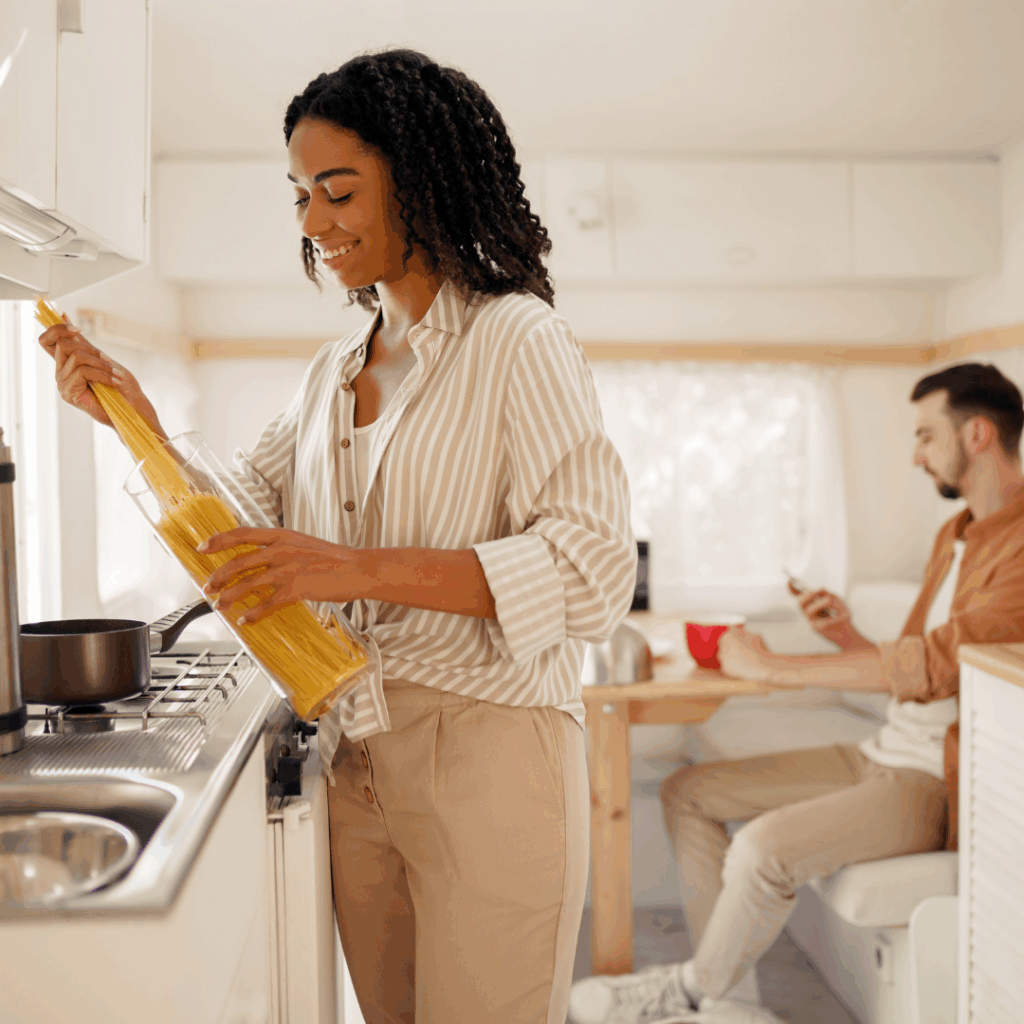 Woman cooking at a RV stovetop